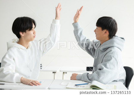 Young people high-fiving Young people high-fiving 137265133