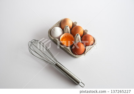 Natural eggs in biodegradable packaging, one egg opened showing rich yellow yolk. Natural eggs in biodegradable packaging, one egg opened showing rich yellow yolk. 137265227