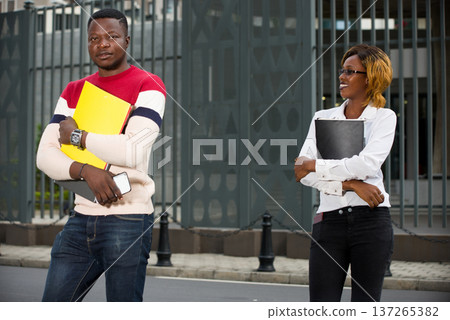 Group of two happy students outdoors Group of two happy students outdoors 137265382