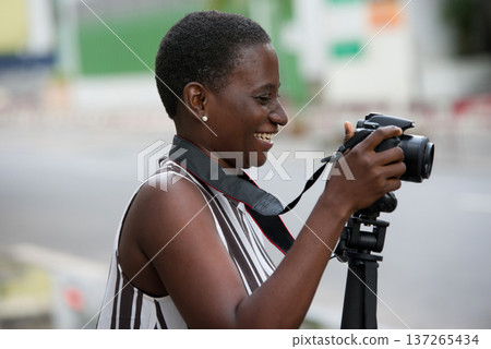 traveling girl taking pictures in town 137265434