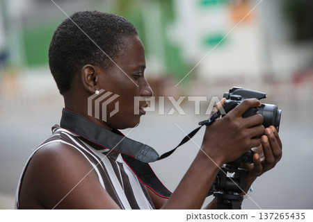 traveling girl taking pictures in town 137265435