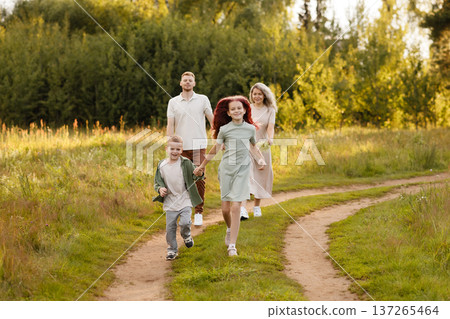 Candid Snapshot Of Loved Ones Sharing Lively Stroll Beneath Shining Sunlight In Wild Surroundings Candid Snapshot Of Loved Ones Sharing Lively Stroll Beneath Shining Sunlight In Wild Surroundings 137265464