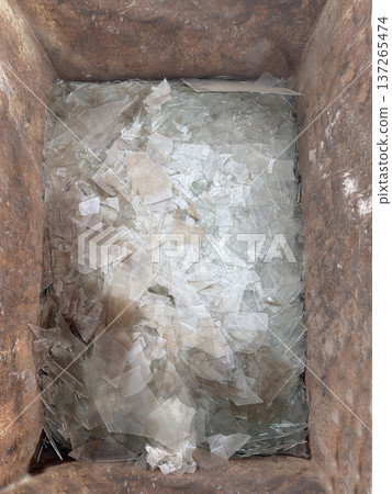 Broken glass from industrial waste produced during the demolition of a house 137265474