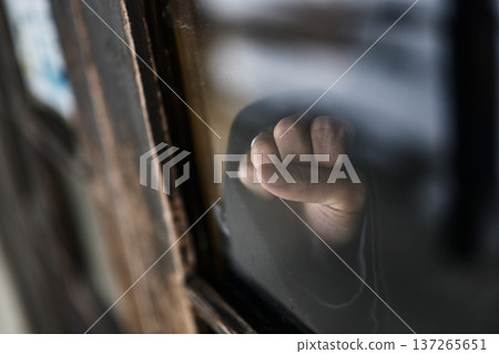 Window glass and hand 137265651