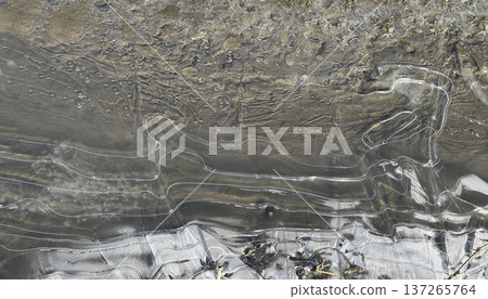 Patterns of ice on a frozen stream on a cold winter morning Patterns of ice on a frozen stream on a cold winter morning 137265764