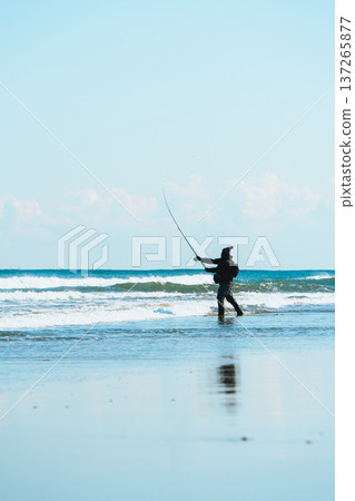 Fisherman standing in the waves Fisherman standing in the waves 137265877
