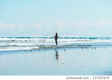 Fisherman standing in the waves Fisherman standing in the waves 137265878