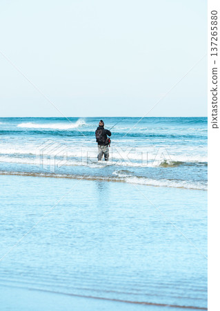 Fisherman standing in the waves Fisherman standing in the waves 137265880
