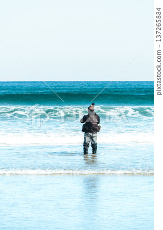 Fisherman standing in the waves Fisherman standing in the waves 137265884