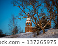 Ancient Bell Tower in Snowy Winter Landscape 137265975