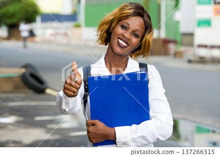 Portrait of smiling university student standing outside on the road to class 137266315