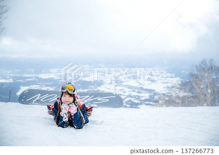 A woman enjoying winter sports on a winter slope 137266773