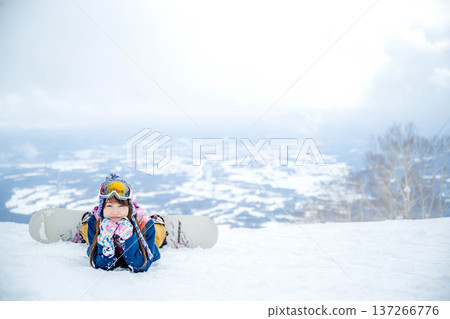 A woman enjoying winter sports on a winter slope 137266776