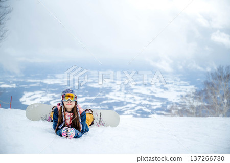 A woman enjoying winter sports on a winter slope 137266780