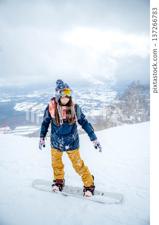 A woman enjoying winter sports on a winter slope 137266783