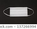 White nonwoven mask placed on a black background 137266994