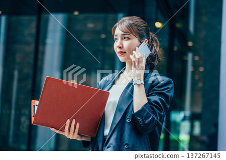 Business woman making phone call in office Business woman making phone call in office 137267145