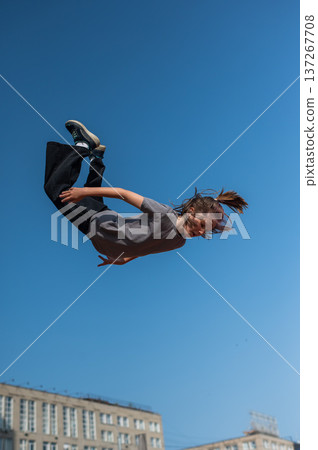 A girl jumps on an outdoor trampoline. A girl jumps on an outdoor trampoline. 137267708
