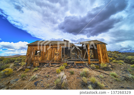 Abandoned Wooden House Under Dramatic Sky in California Desert Landscape 137268329