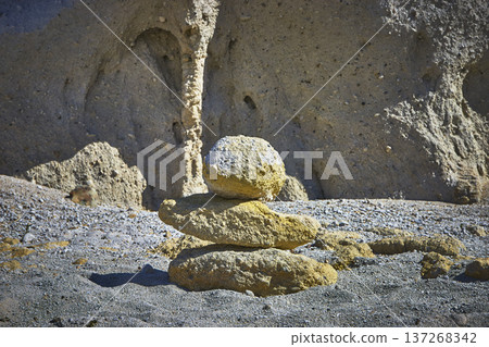 Rock Cairn Stone Stack in Sunlit Arid Landscape with Eroded Natural Backdrop Rock Cairn Stone Stack in Sunlit Arid Landscape with Eroded Natural Backdrop 137268342