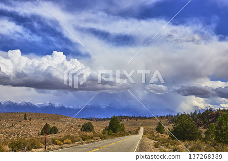 Highway 120 Road Leading to Mountains Under Dramatic Clouds in California Highway 120 Road Leading to Mountains Under Dramatic Clouds in California 137268389