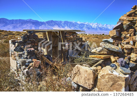 Abandoned Stone Structure in California Desert with Mountain Range in Bright Sunlight Abandoned Stone Structure in California Desert with Mountain Range in Bright Sunlight 137268485