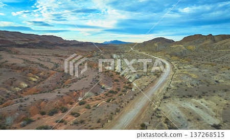 Aerial Desert Road and Rugged Hills near Las Vegas Nevada under Dramatic Sky Aerial Desert Road and Rugged Hills near Las Vegas Nevada under Dramatic Sky 137268515