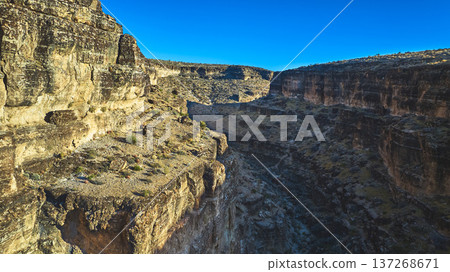 Aerial Cowboy Canyon Rugged Cliffs and Desert Landscape Golden Hour Mountain 137268671