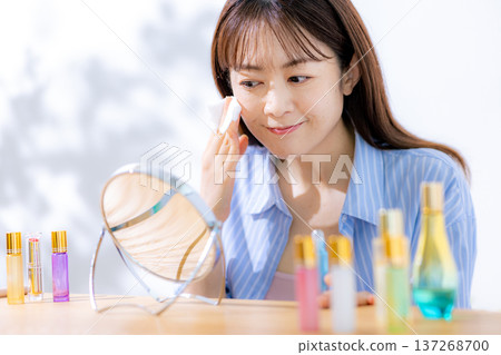 Woman doing make-up Woman doing make-up 137268700