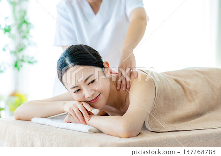 Middle-aged woman receiving beauty treatment Middle-aged woman receiving beauty treatment 137268783