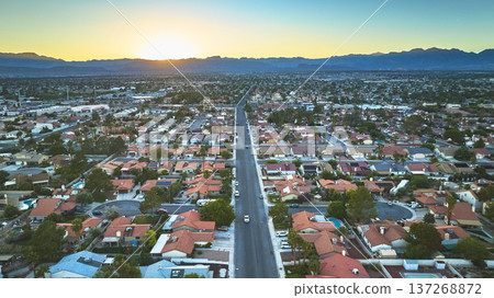 Aerial Las Vegas Suburban Neighborhood Road and Mountains at Golden Hour 137268872