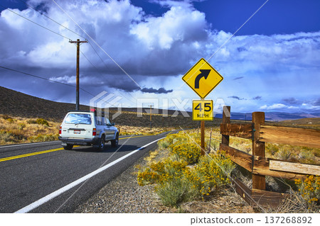 California Highway 120 Road Curve Sign Speed Limit and Car Travel Scene California Highway 120 Road Curve Sign Speed Limit and Car Travel Scene 137268892