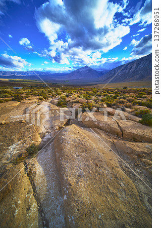 Rocky Wagon Trail Leading to Dramatic Mountain Landscape Under Vibrant Sky Rocky Wagon Trail Leading to Dramatic Mountain Landscape Under Vibrant Sky 137268951
