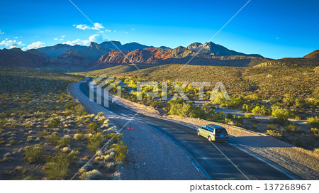 Aerial Red Rock Canyon Road with Car and Mountain Landscape Nevada 137268967