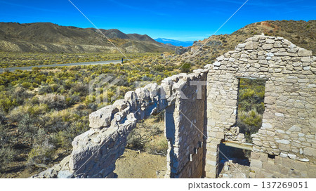Abandoned Stone Structure Desert Landscape and Road California High Desert Abandoned Stone Structure Desert Landscape and Road California High Desert 137269051