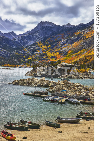 Mountain Lake Dock with Colorful Boats and Fall Foliage Reflections Mountain Lake Dock with Colorful Boats and Fall Foliage Reflections 137269155