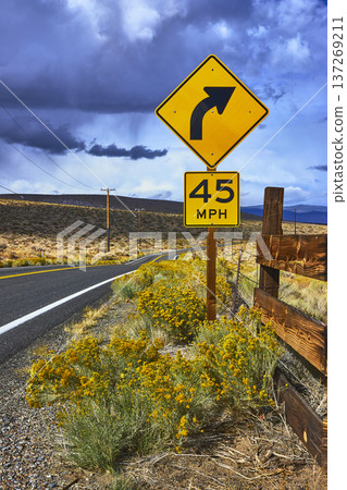 California Highway 120 Curve Warning Sign and Speed Limit Roadside Landscape California Highway 120 Curve Warning Sign and Speed Limit Roadside Landscape 137269211