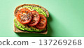 Whole Grain Avocado Toast with Tomato and Chia Seeds on Green Background 137269268