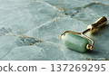 Jade Roller on Marble Surface for Luxurious Skincare Routine 137269295