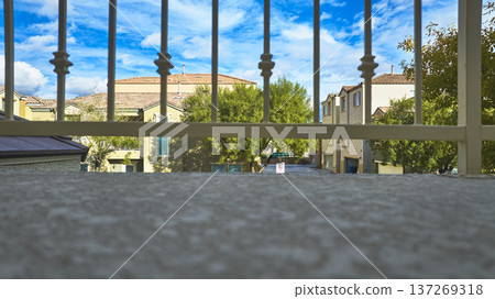 Residential Neighborhood View From Balcony With Railing Trees And Blue Sky 137269318