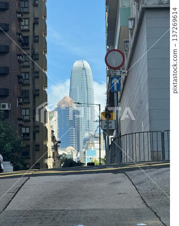 View of modern skyscrapers framed by older buildings on a sunny day in Hong Kong 137269614