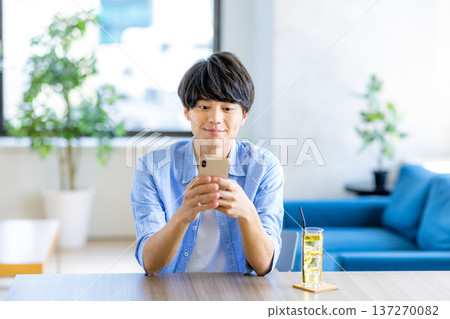 A young man looking at his smartphone 137270082