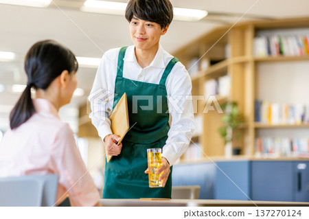 A man working at a cafe A man working at a cafe 137270124