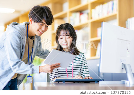 Young men and women working in the office 137270135