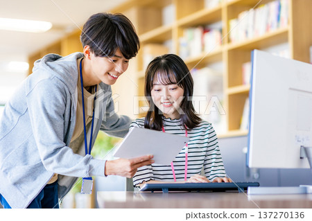 Young men and women working in the office 137270136