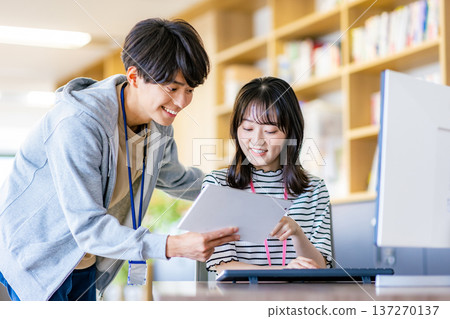 Young men and women working in the office 137270137