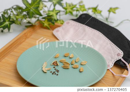 Cardamom seeds and masks. Spice stock photo. Cardamom is said to be effective in preventing hay fever. 137270405