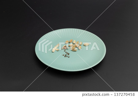 Black background and cardamom seeds. Stock photo of spices. Cardamom is said to be effective in preventing hay fever. Black background and cardamom seeds. Stock photo of spices. Cardamom is said to be effective in preventing hay fever. 137270458