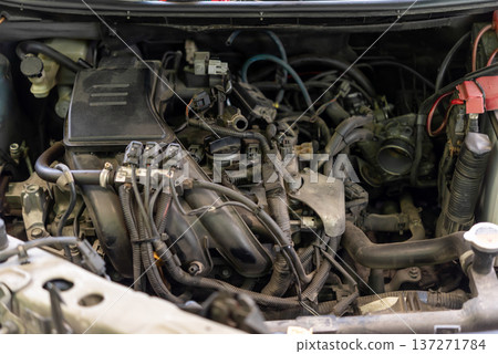 Close up car engine bay with intake manifold wiring and throttle body showing automotive maintenance repair and mechanical inspection in vehicle service workshop Close up car engine bay with intake manifold wiring and throttle body showing automotive maintenance repair and mechanical inspection in vehicle service workshop 137271784