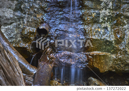Rusted Pipes and Water Flow Over Wet Rocks in Mountain Stream Detail Rusted Pipes and Water Flow Over Wet Rocks in Mountain Stream Detail 137272022